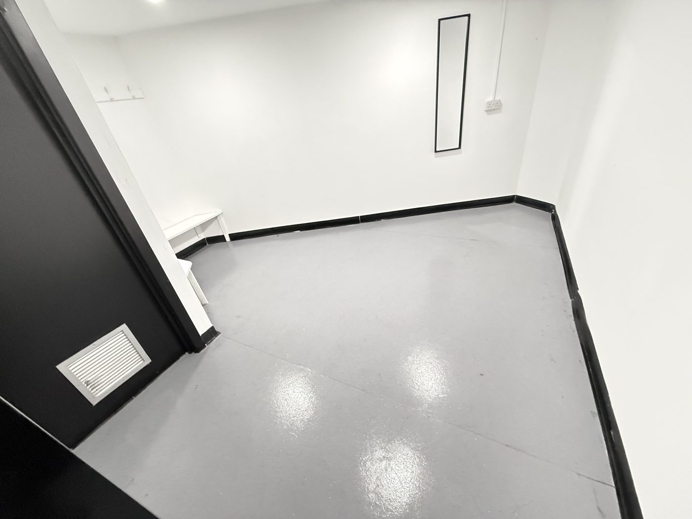 A clean changing room with bench and mirror at a leisure site cleaned by Cadence Clean