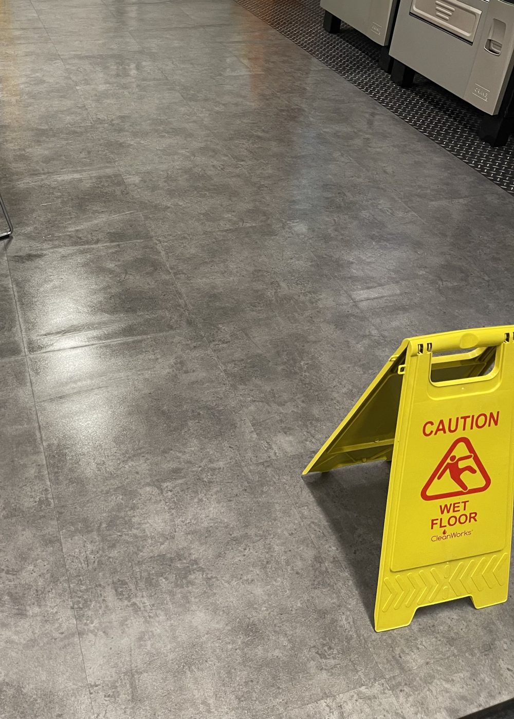 A freshly cleaned shop floor with stone effect tiles at a commercial premises in Derby