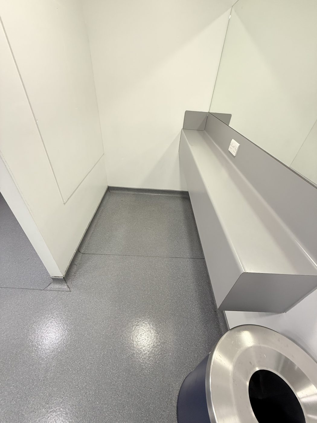 A spotless washroom vanity area with mirror at an office cleaned by Cadence Clean